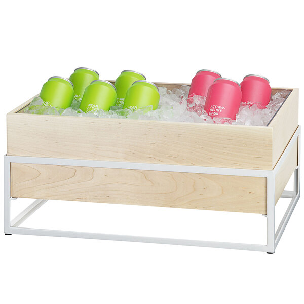 A Cal-Mil maple wood ice housing with green cans and ice.