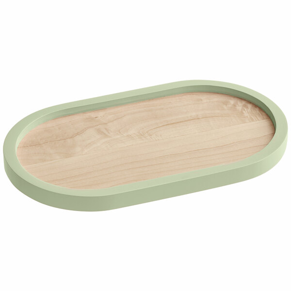 A Cal-Mil maple wood oval serving tray with a light green rim.