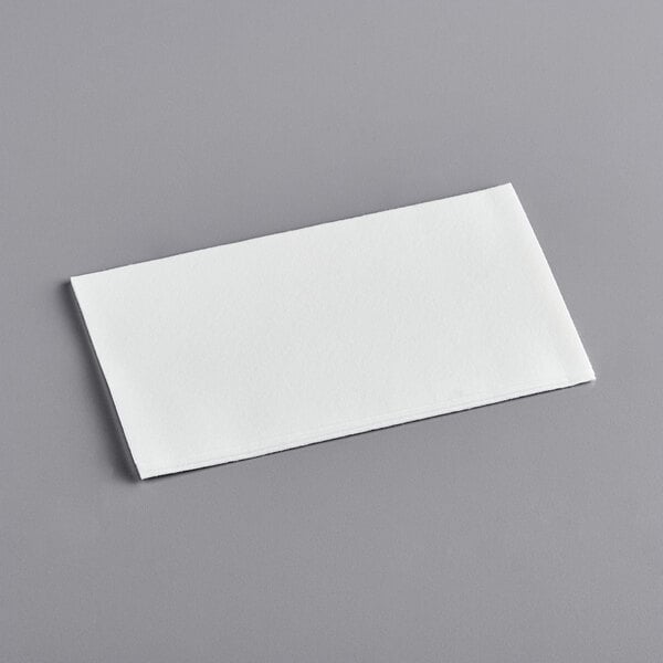 a white napkin on a gray surface