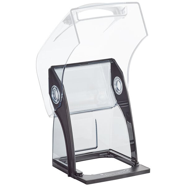 A clear plastic box with a black base and lid labeled "Vitamix Twist Lock Copolyester Plastic Back Cover" on a counter.