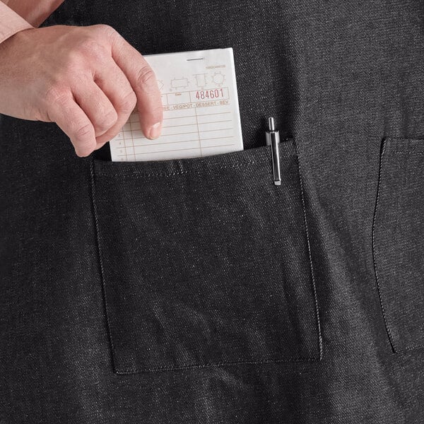 a person putting a piece of paper in a pocket