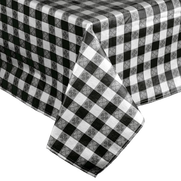 A black and white checkered Intedge vinyl table cover on a table.