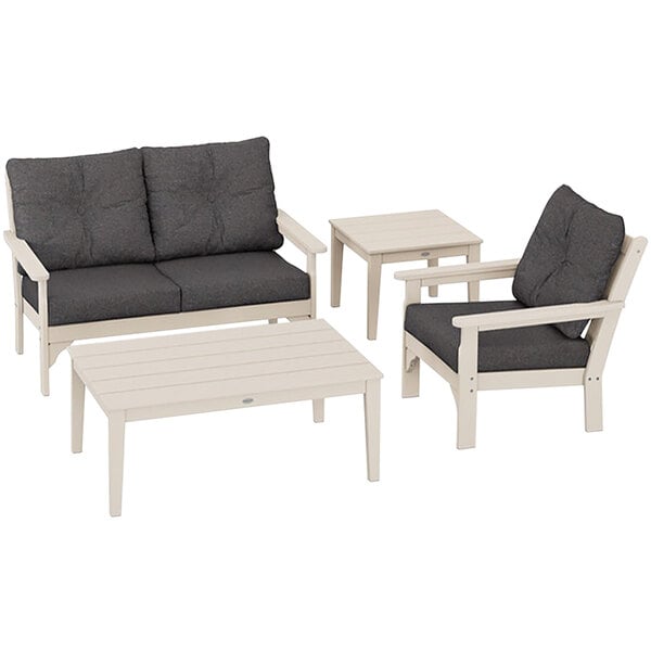 A sand POLYWOOD chair and table with grey cushions.