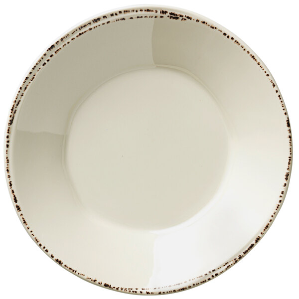 A Libbey ivory melamine bowl with brown specks.