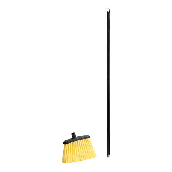 A Carlisle heavy duty broom with a black pole.