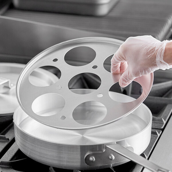 a hand holding a circular object