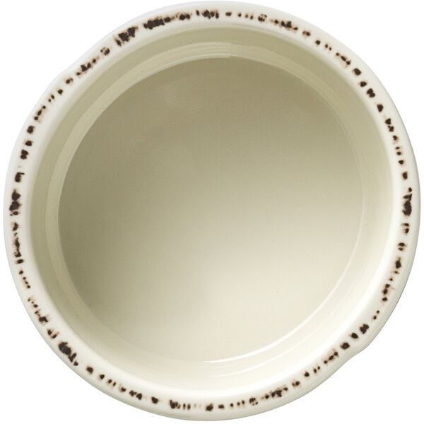 A white Libbey melamine bouillon cup with black specks.
