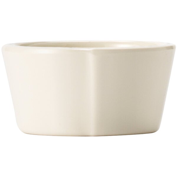 A Libbey Farmhouse ivory melamine sauce cup with a handle.