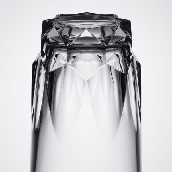 An Arcoroc Artic clear beverage glass with a diamond pattern on a table.