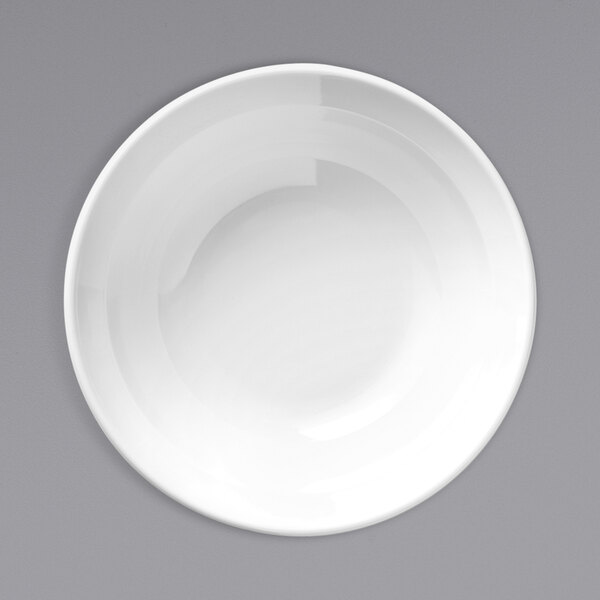 A Libbey Basics bright white melamine bowl on a gray surface.