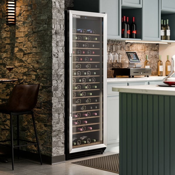 A tall, single temperature commercial wine cooler with a full glass door, filled with wine bottles.