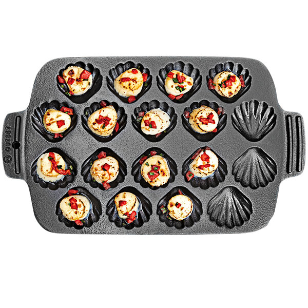 An Outset cast iron scallop grill pan with food in it.