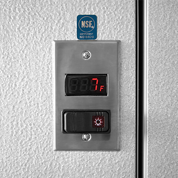 A metal panel with a digital thermometer displaying a temperature of -7 degrees.