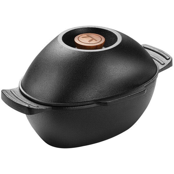 An Outset cast iron mussel pot with a wooden lid.