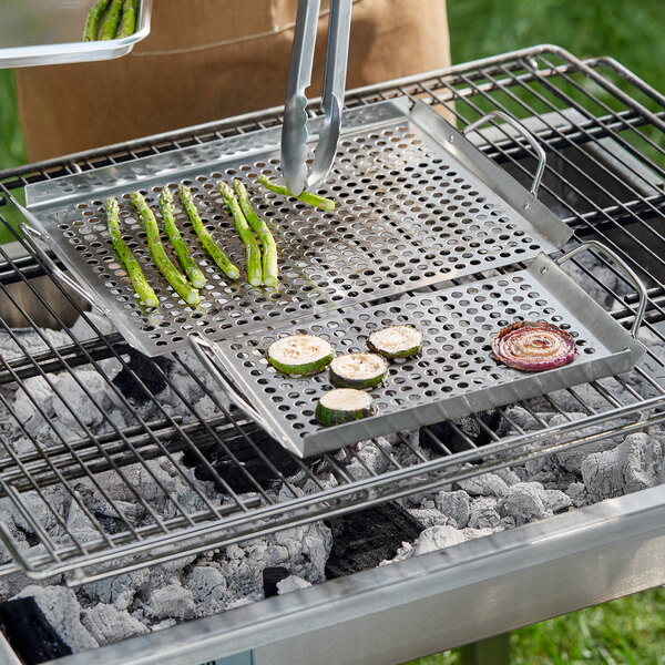 Stainless steel grill trays with vegetables grilling.