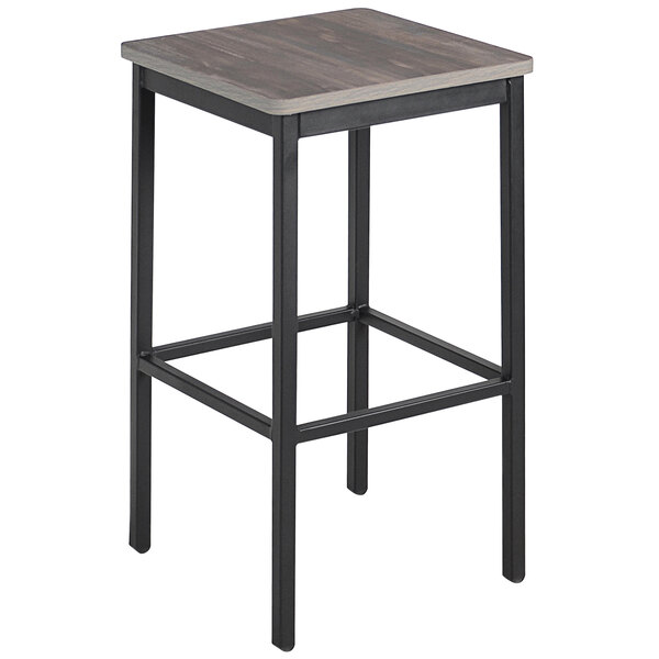 A BFM Seating black steel backless barstool with a wood seat.