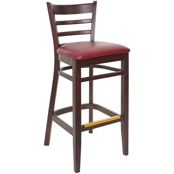 A BFM Seating Berkeley beechwood barstool with burgundy vinyl seat.