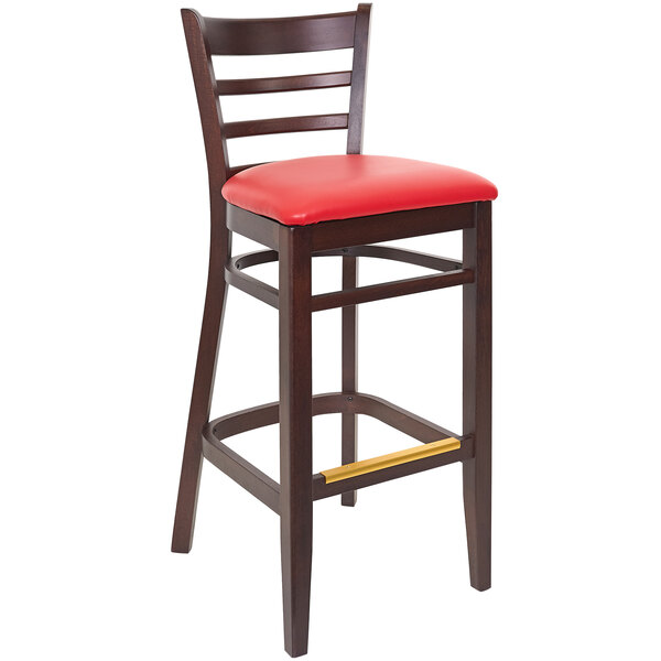 A BFM Seating Berkeley dark walnut beechwood barstool with a red vinyl seat.