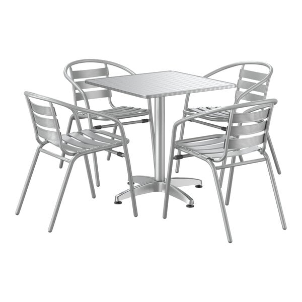 A Lancaster Table & Seating chrome square outdoor table with four silver arm chairs.