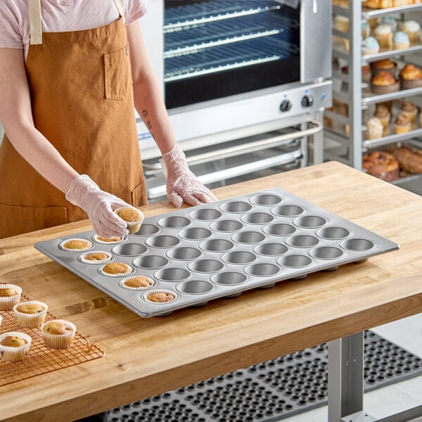 A large aluminized steel muffin or cupcake pan with 35 cups, designed for baking multiple cupcakes or muffins at once.