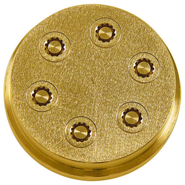A gold metal object with six holes.