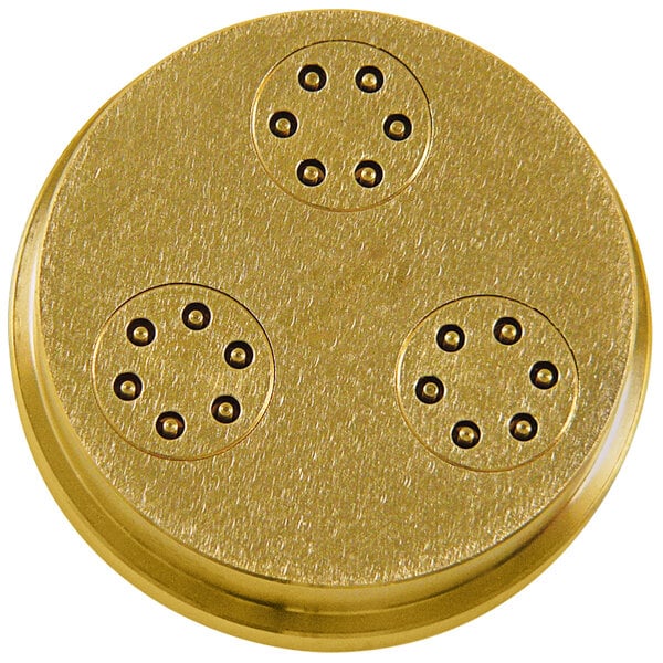 a gold circular object with black dots