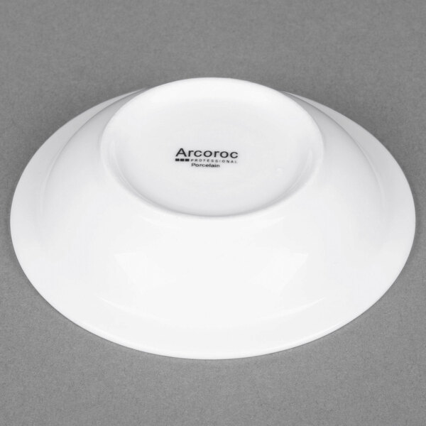 An Arcoroc white porcelain fruit dish with black text that reads "Arcoroc"