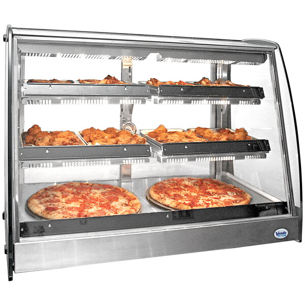 A Vendo hot food display case with pizzas and chicken on wide shelves.