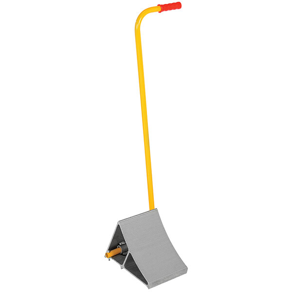 An aluminum wheel chock with a yellow handle.