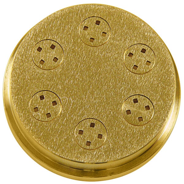 A gold circular pasta die with holes in it.