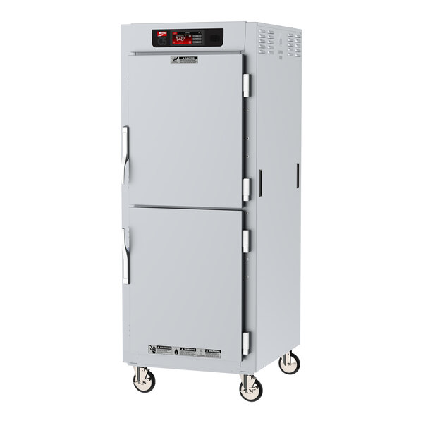 A white metal Metro C5 holding cabinet with two doors on wheels.
