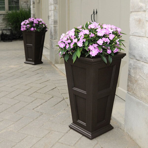 An espresso Mayne Fairfield planter with purple flowers.