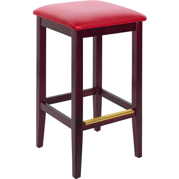 A BFM Seating Stockton dark mahogany beechwood barstool with a red vinyl seat