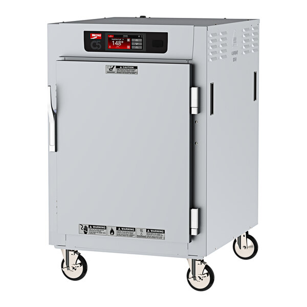 A Metro C5 holding cabinet with a solid door and wheels.