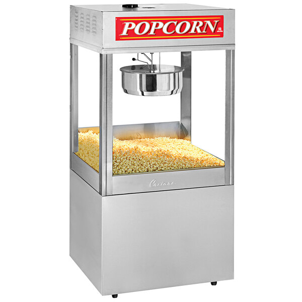 A Cretors popcorn machine with a large container of popcorn.