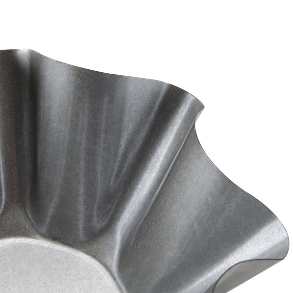 A Chicago Metallic metal tortilla shell pan with a wavy edge.