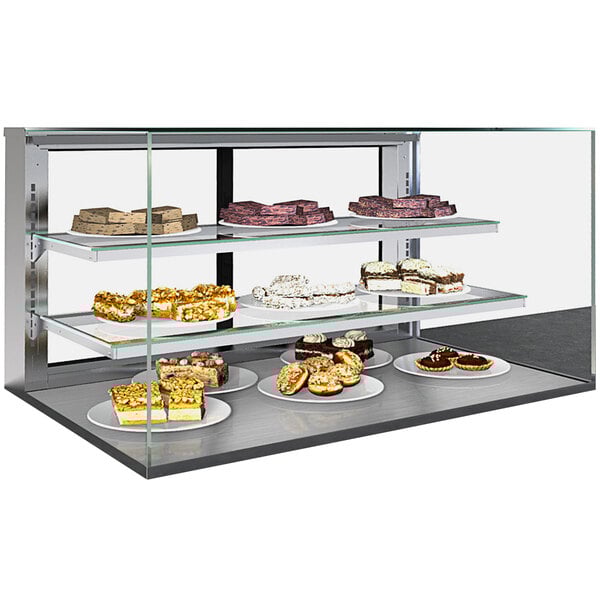 A Structural Concepts countertop bakery display case with plates of food on shelves.