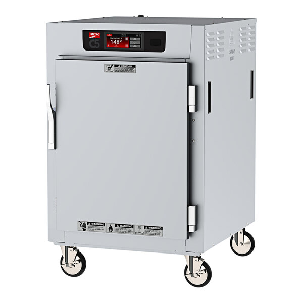A white Metro C5 half size holding cabinet with wheels and a solid door.