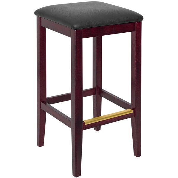 A BFM Seating dark mahogany beechwood barstool with a black vinyl seat.