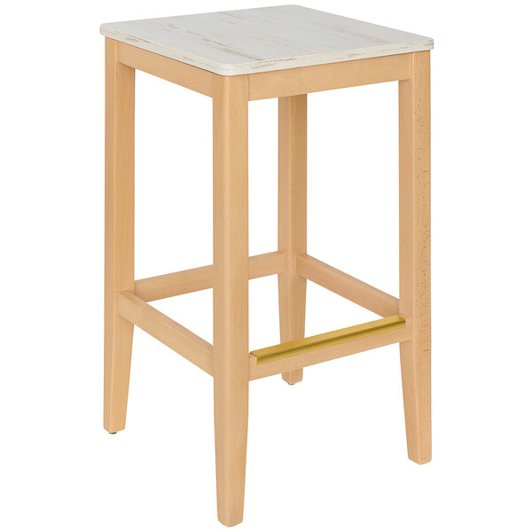 a wooden stool with a gold bar