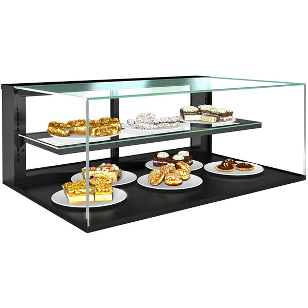 A Structural Concepts countertop bakery display case with shelves holding cakes and desserts.