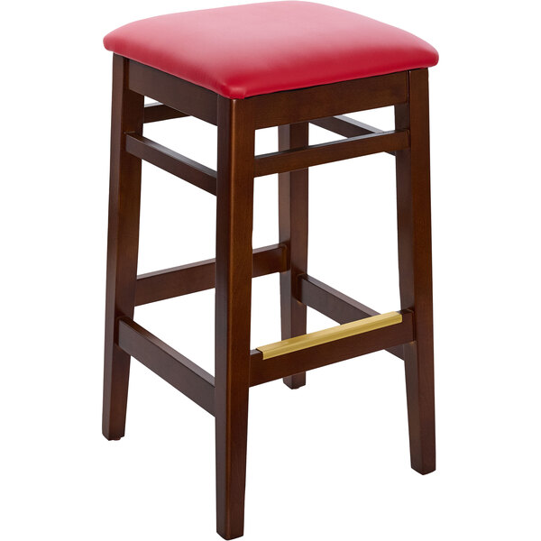 a stool with a red cushion