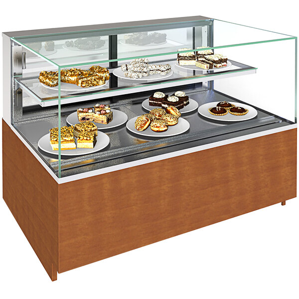 A Structural Concepts non-refrigerated bakery display case with shelves holding a variety of desserts.