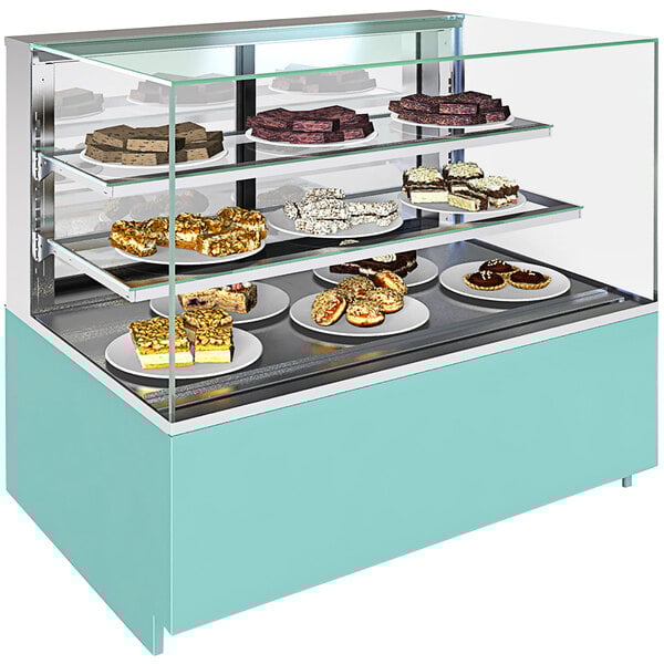 A Structural Concepts non-refrigerated bakery display case with cakes and pastries on two shelves.