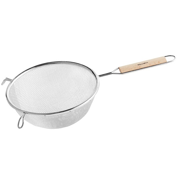 A Vollrath stainless steel strainer with a wood handle.