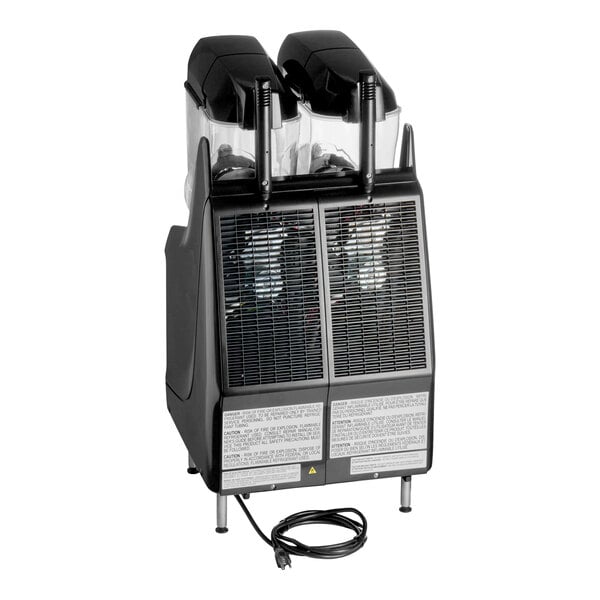 A black and silver double beverage machine with two clear containers on top, dispensing levers, ventilation grilles, and a power cord at the base.