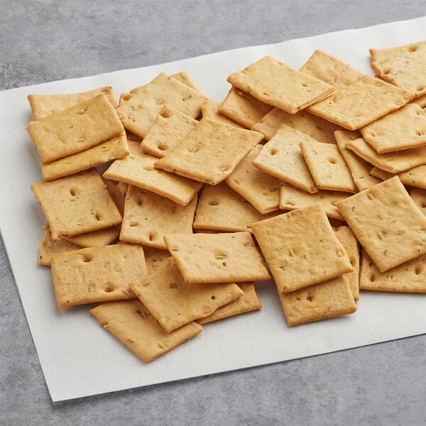 A pile of Meliora Baked Mini Rosemary Focaccia Bites on a white napkin.