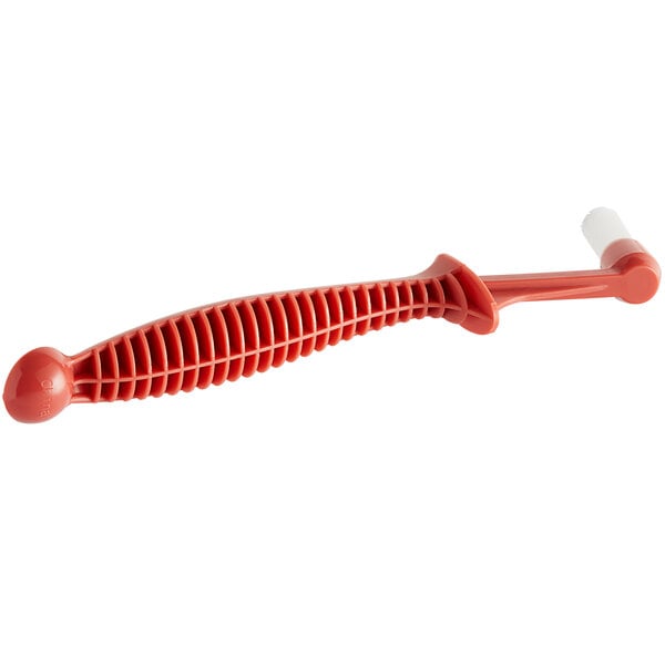 A red plastic Urnex espresso machine brush with a white tip.
