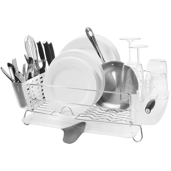 An OXO stainless steel dish drying rack with plates and utensils on it.