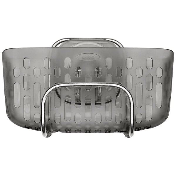 An OXO stainless steel sink caddy with a metal handle.